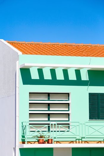 green and white concrete building under blue sky