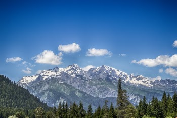 Green and White Snow-capped Mountain Under Blue Skies