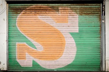 green and yellow s graphic roll-up door
