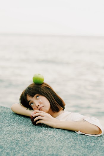 Green Apple on Girl's Head