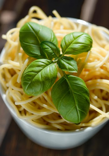 Green Basil Leaves on Top of Pasta
