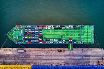 Green Cargo Boat Beside Dock