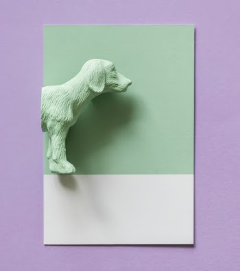 Green Ceramic Dog Figurine Beside Green Paper