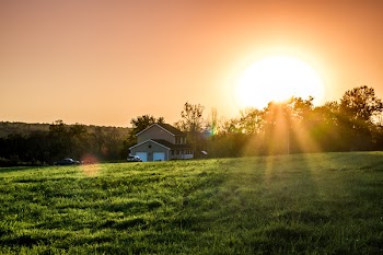 Green Field and Brown and White House during Sunrise