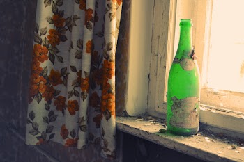 Green Glass Bottle Beside Window