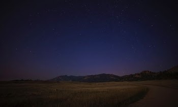 green grass field near mountain at night time photo