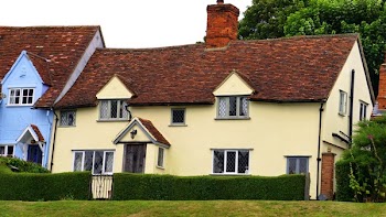 Green Grass Lawn Near White and Brown Painted House at Daytime