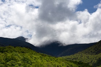 Green Hill Under White Clouds and Blue Sky