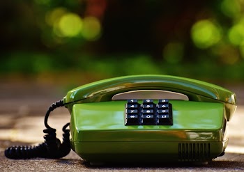 Green Ip Phone on Gray Surface