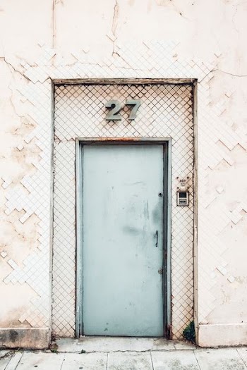 green metal door closed at daytime
