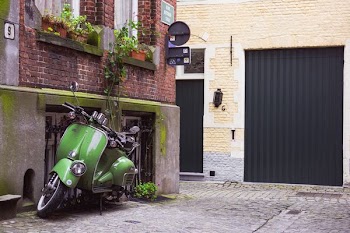 green motor scooter on a street