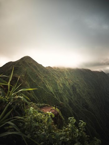 green mountain under cloudy sky