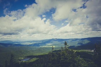 Green Mountain Under Cloudy Sky during Daytime