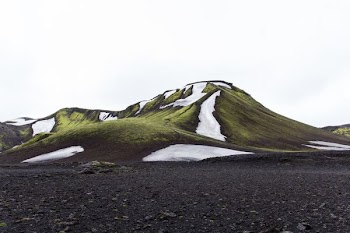 green mountain under white sky
