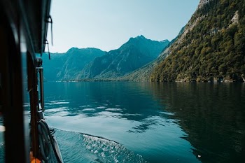 green mountains beside body of water at daytime