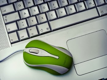 Green Mouse on silver Laptop