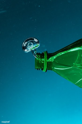 Green plastic bottle polluting the ocean | Free  photo - 2315653