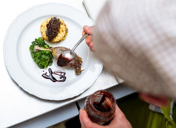 Green Salad Caviar on Beige Pancake Garnished With Chocolate Syrup on White Round Ceramic Dining Plate