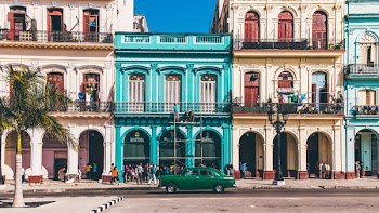 Green Sedan Parked on Front of Building