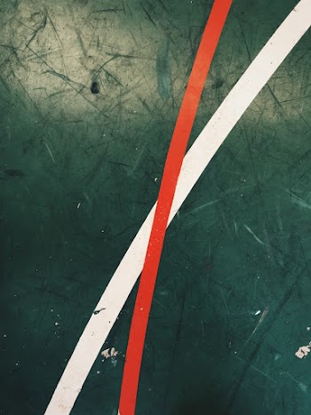 Green Surface With White and Red Linage Close-up Photography