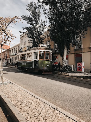 Green Tram Near Brown Building