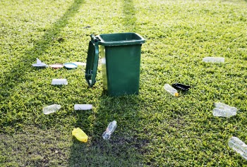 Green Trash Bin on Green Grass Field