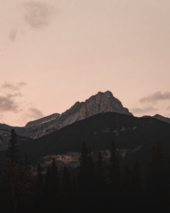 Green Trees Near Mountain Under Cloudy Sky · Free Stock Photo
