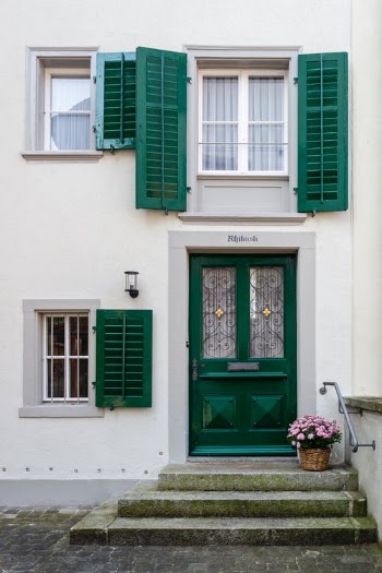 Green Wooden Door on White Concrete Building · Free Stock Photo