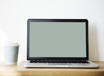 Grey and Black Laptop Beside White and Teal Coffee Cup