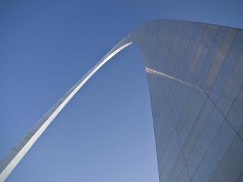 Grey Arc Building Under Blue Sky