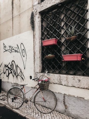 Grey Bicycle Parked Near Concrete Wall