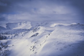Grey Cloudy Sky over Snow Covered Mountain Ranges
