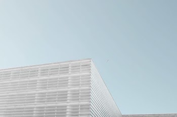 grey concrete building under clear blue sky