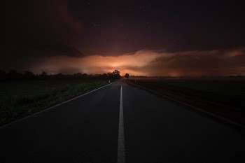 grey concrete road under cloudy sky during daytime