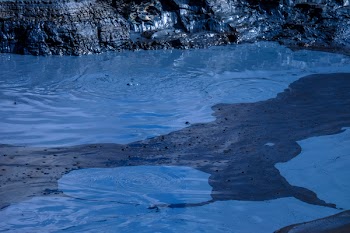 Grey Rock Formation Near Body of Water