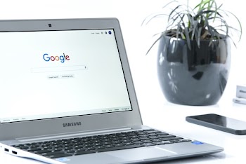 Grey Samsung Laptop Turned on Beside Black Smartphone