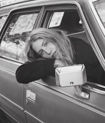 Grey scale Photo of Woman Looking Through Car Window