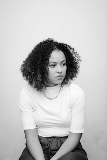 Grey scale Photo of Woman with Curly Hair  Wearing White Turtleneck T-Shirt