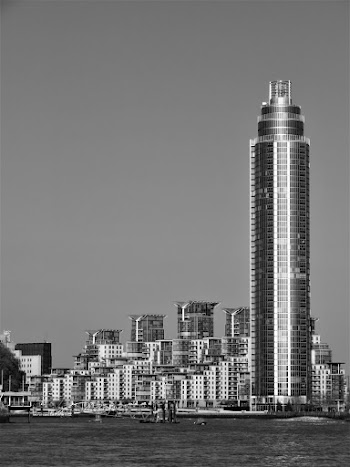 Grey Scale Photography of High-rise Building Near Body of Water