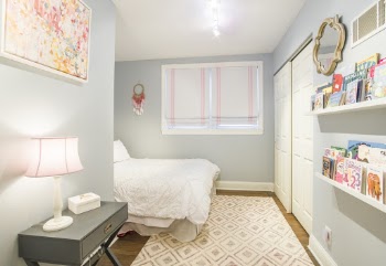 Grey Stand Table by the Wall Near Bed and Window