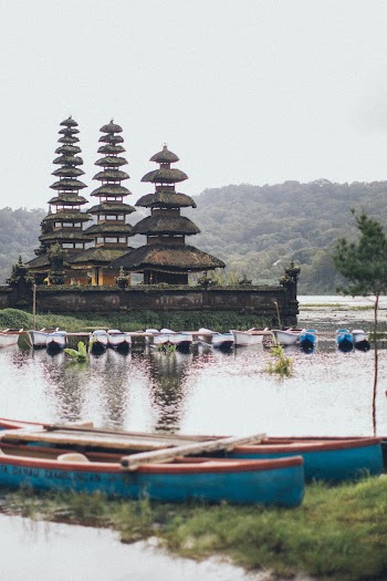 Grey Temple Beside Body of Water With Boats
