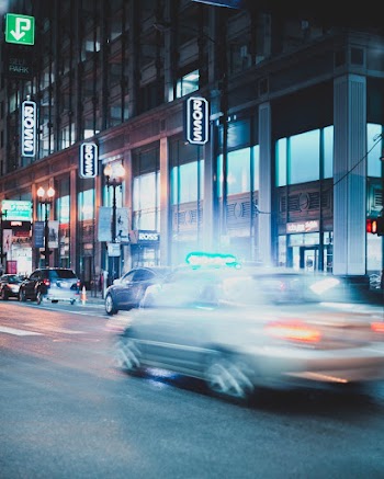 Grey Vehicle Beside Concrete Building