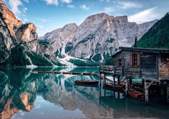 grey wooden cabin near body of water
