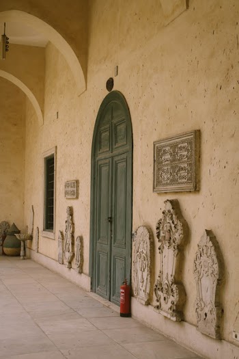 Grey Wooden Door Between Beige Concrete Wall