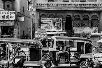 greyscale auto rickshaw and people