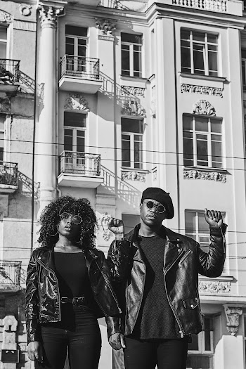 Greyscale Photo of Man and Woman Standing Outside