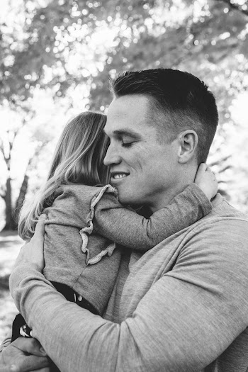 Greyscale Photo of Man Carrying Girl