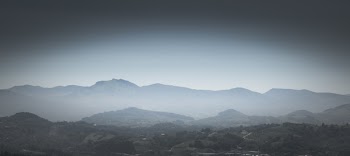 Greyscale Photo of Mountains With Mist