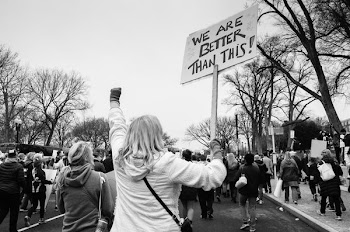 greyscale photo of people protesting with We Are Better Than This signages