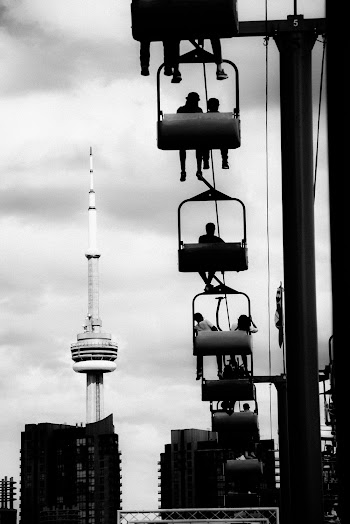 Greyscale Photo Of People Riding A Lift